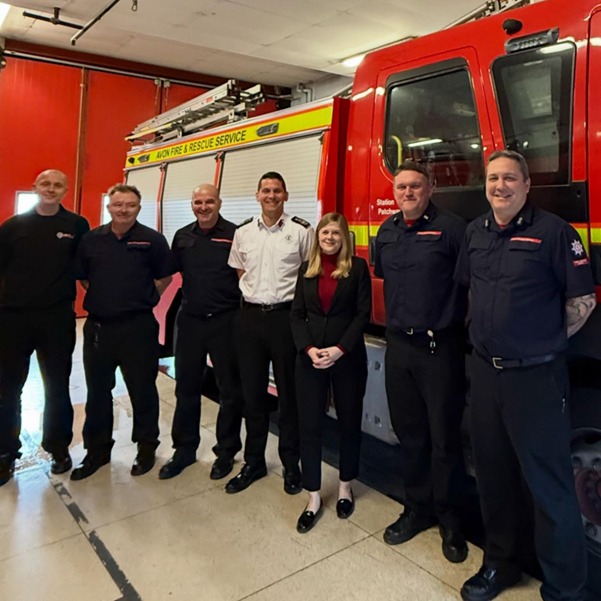 Claire Hazelgrove (middle right) with Avon and Fire Rescue Service Chief Fire Officer Matt Cook, alongside some of his team members at Patchway Fire Station